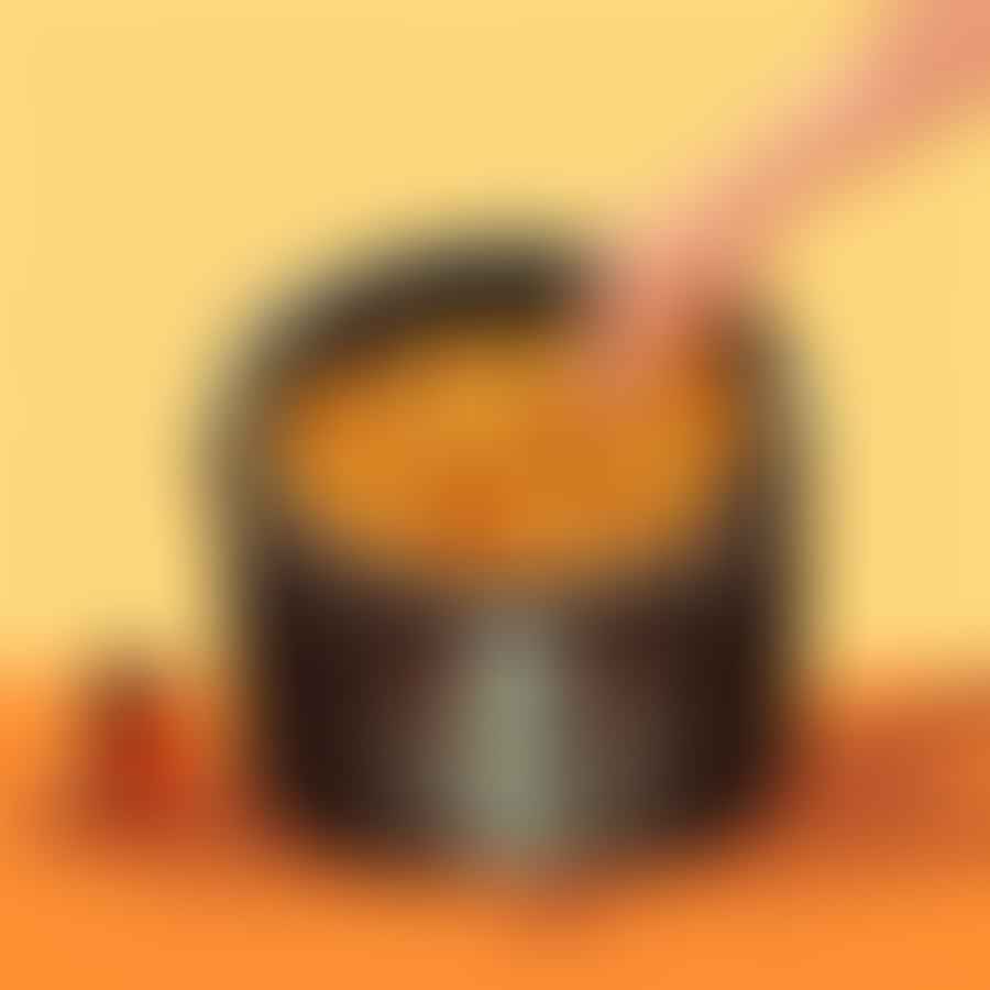 Hand removing basket from air fryer, with crispy fries ready to be served